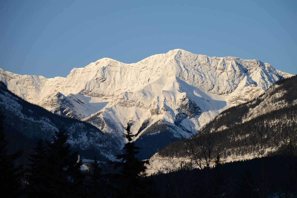 17 Ridge Of Goatview Peak Peaks Out Between The Mountains Next To Canmore From Trans Canada Highway In Winter Early Morning